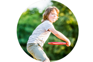 A boy throwing a frisbee