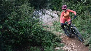 Female mountain biker on single track in new Leatt clothing