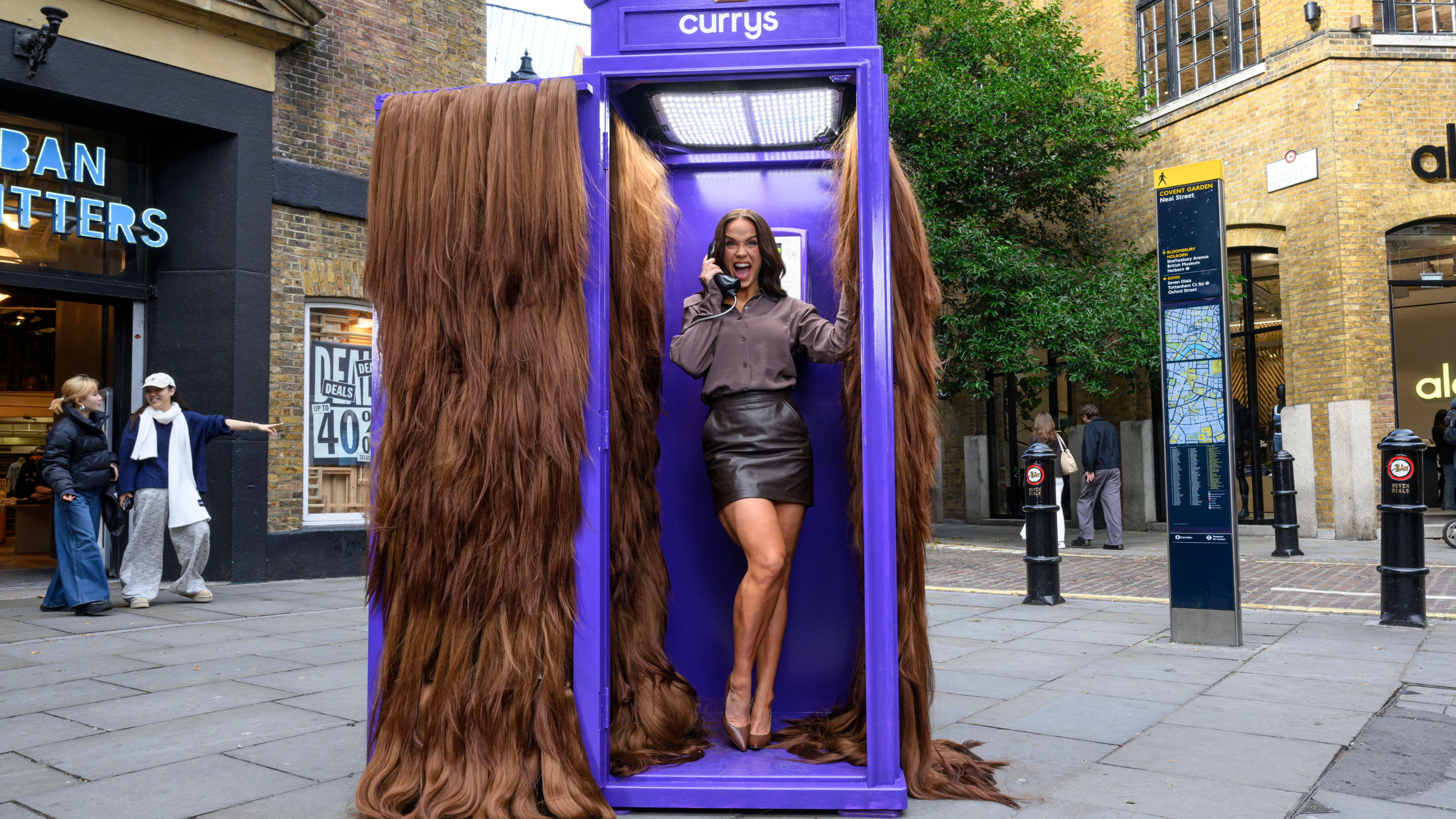 Vicky Pattison answering the phone in Currys' purple Hairline phone box.
