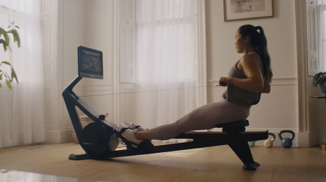 An image of a woman using the Hydrow Wave at home