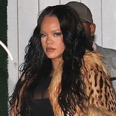 Rihanna wears a vintage Gucci by Tom Ford 1999 fur jacket with a sheer black dress to celebrate her 38th birthday