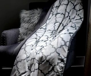 Luxome Weighted Blanket on an armchair.