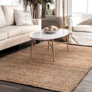 A jute rug in a neutral living room design scheme