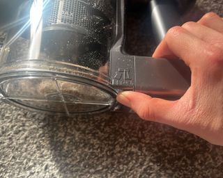 Removing dust bucket from the Ultenic cordless vacuum cleaner