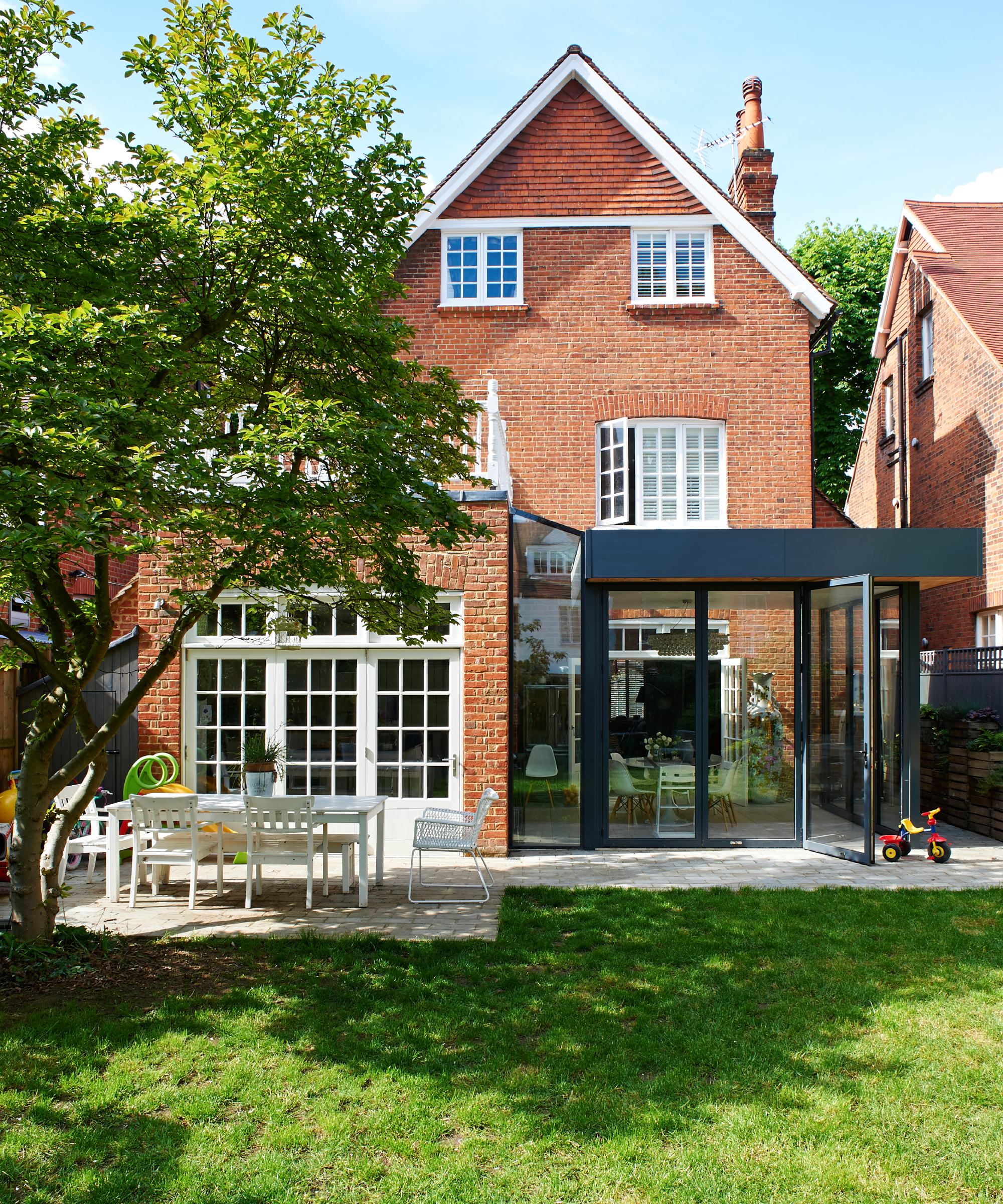 Pub orig. Period Arts and Crafts house late 19th, early 20th century, black steel and glass modernist extension, garden