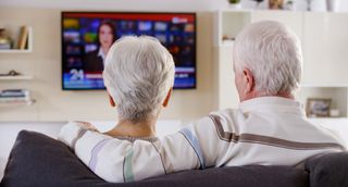 older couple watching TV on the news