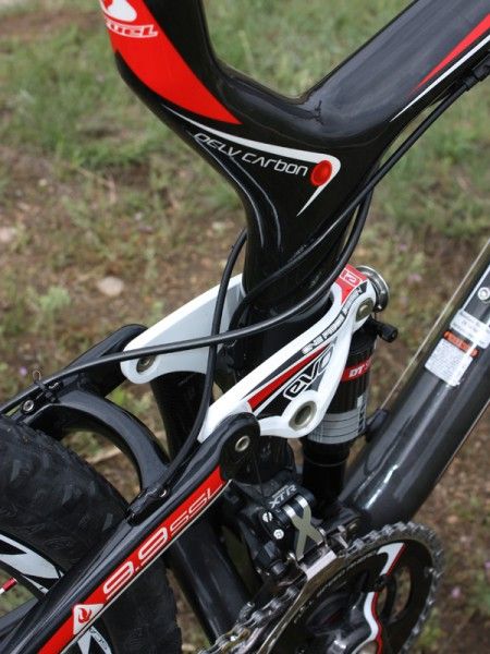 Both the rear derailleur and brake lines criss-cross behind the seat tube to keep them away from rider's legs during suspension movement.