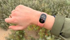 Grace Walsh wearing the new Fitbit Edge on wrist while walking