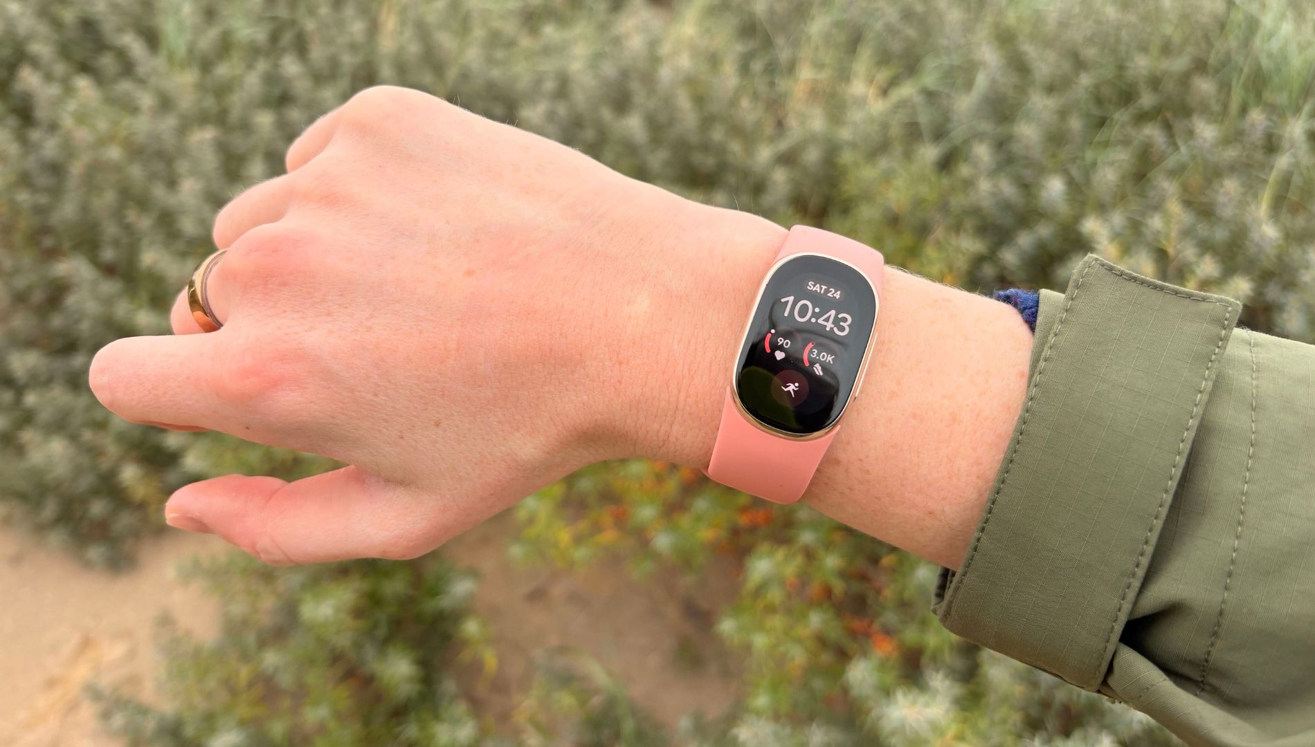 Grace Walsh wearing the new Fitbit Edge on wrist while walking
