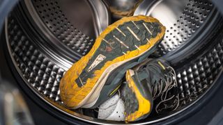 A pair of trail shoes inside a washing machine drum