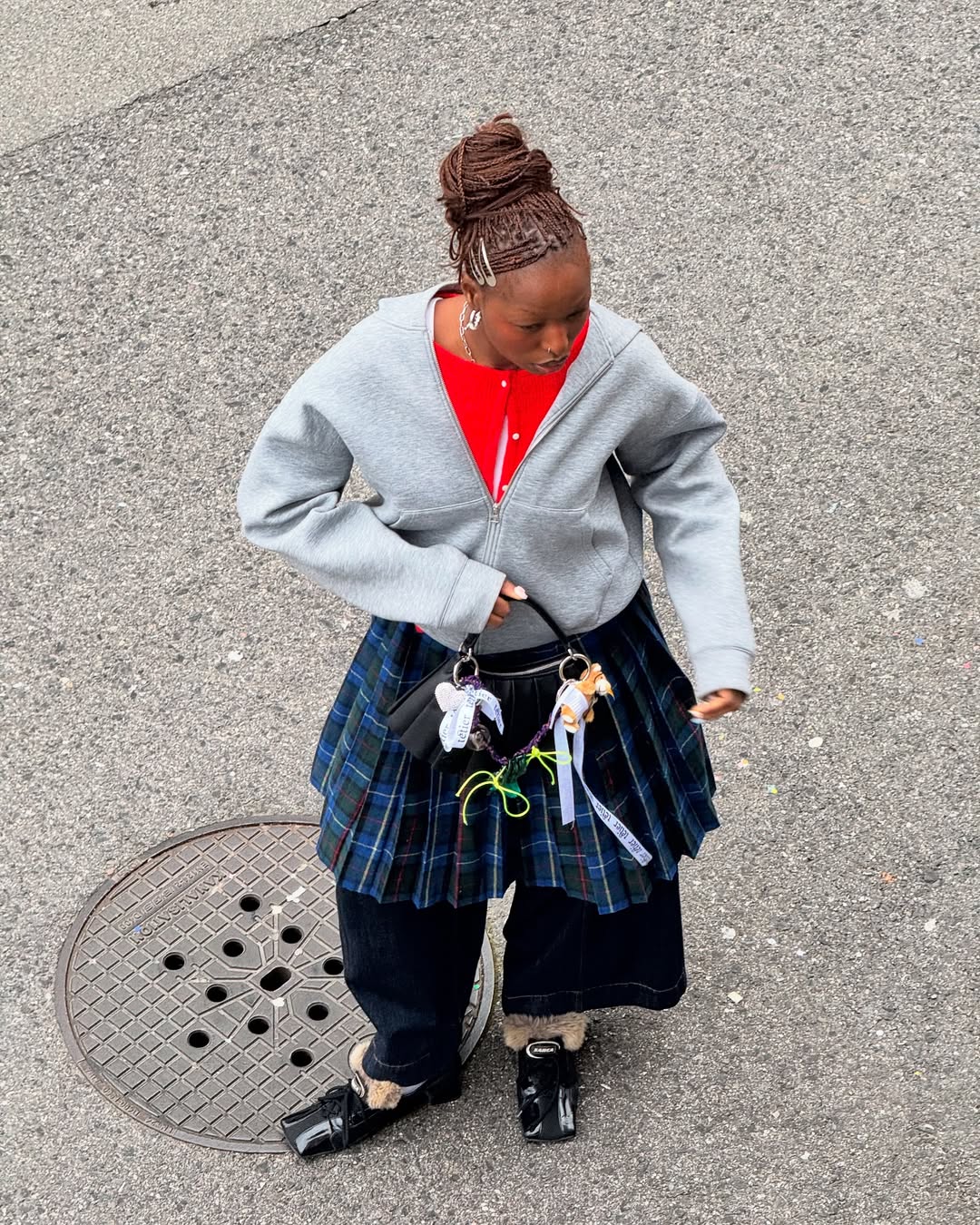 woman on the street wearing a skirt and sweater