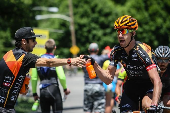 Tom Zirbel (Optum) goes after a bottle in the feed zone