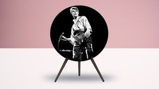 A Bang & Olufsen A9 speaker with a picture of David Bowie holding a microphone on it, in a room with a pink background