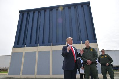 President Trump inspects a border wall prototype.