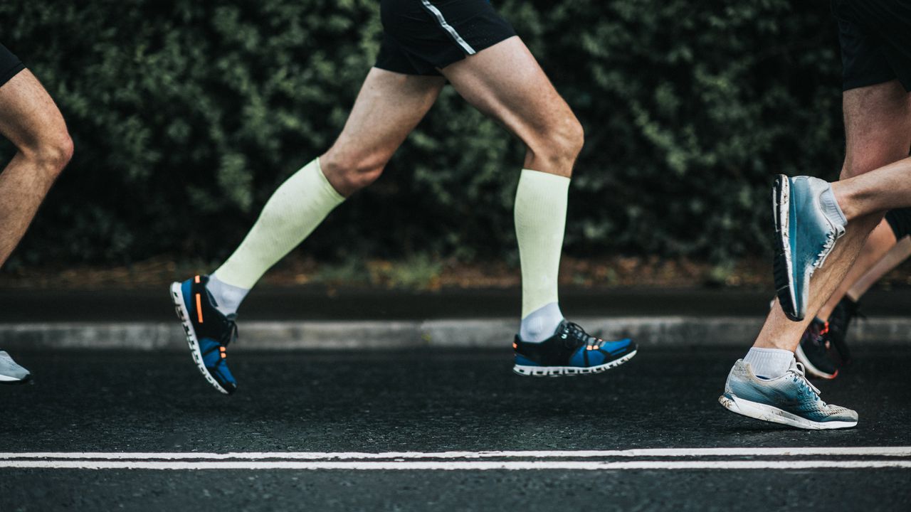 a group of men running on a road