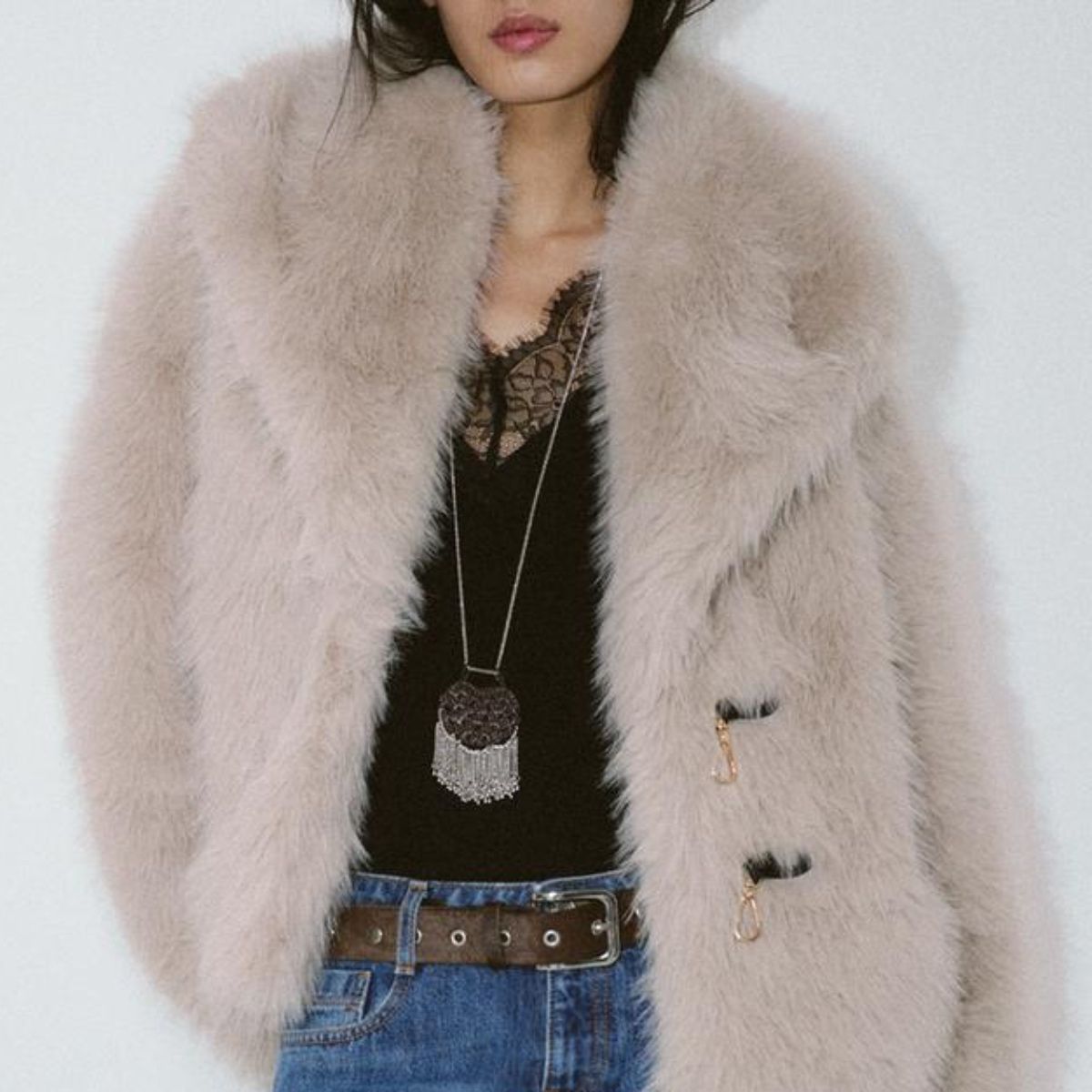 A model wears a Zara faux fur coat and jeans