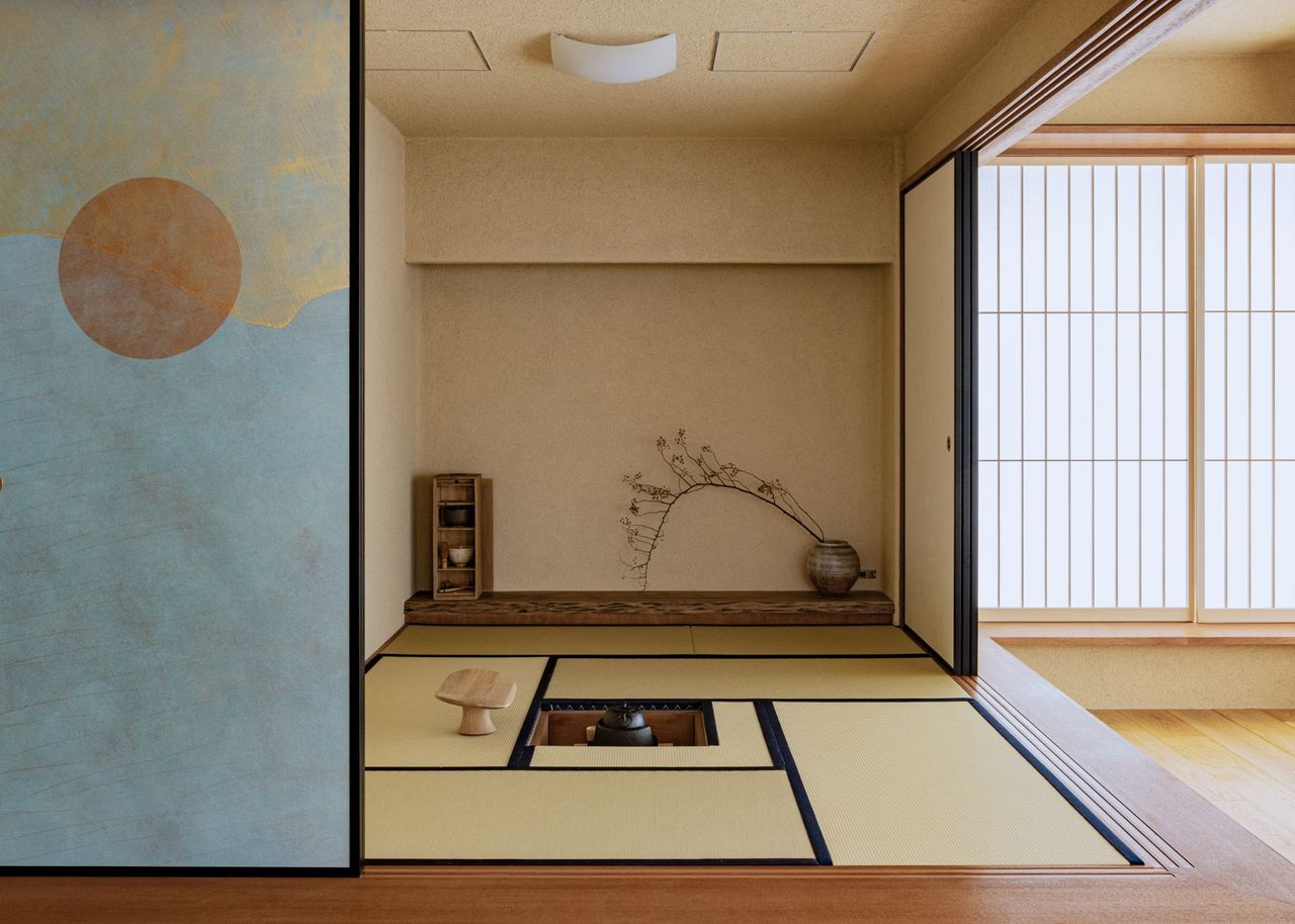 Sliding internal doors painted in blue at the bottom and gold at the top with an orange sun-like circle in the center are opened to reveal a Japanese tea room in a neutral hue with tatami mats