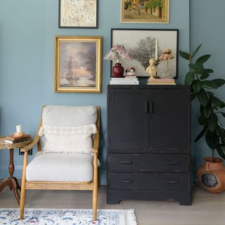 blue living room with armchair and cabinet