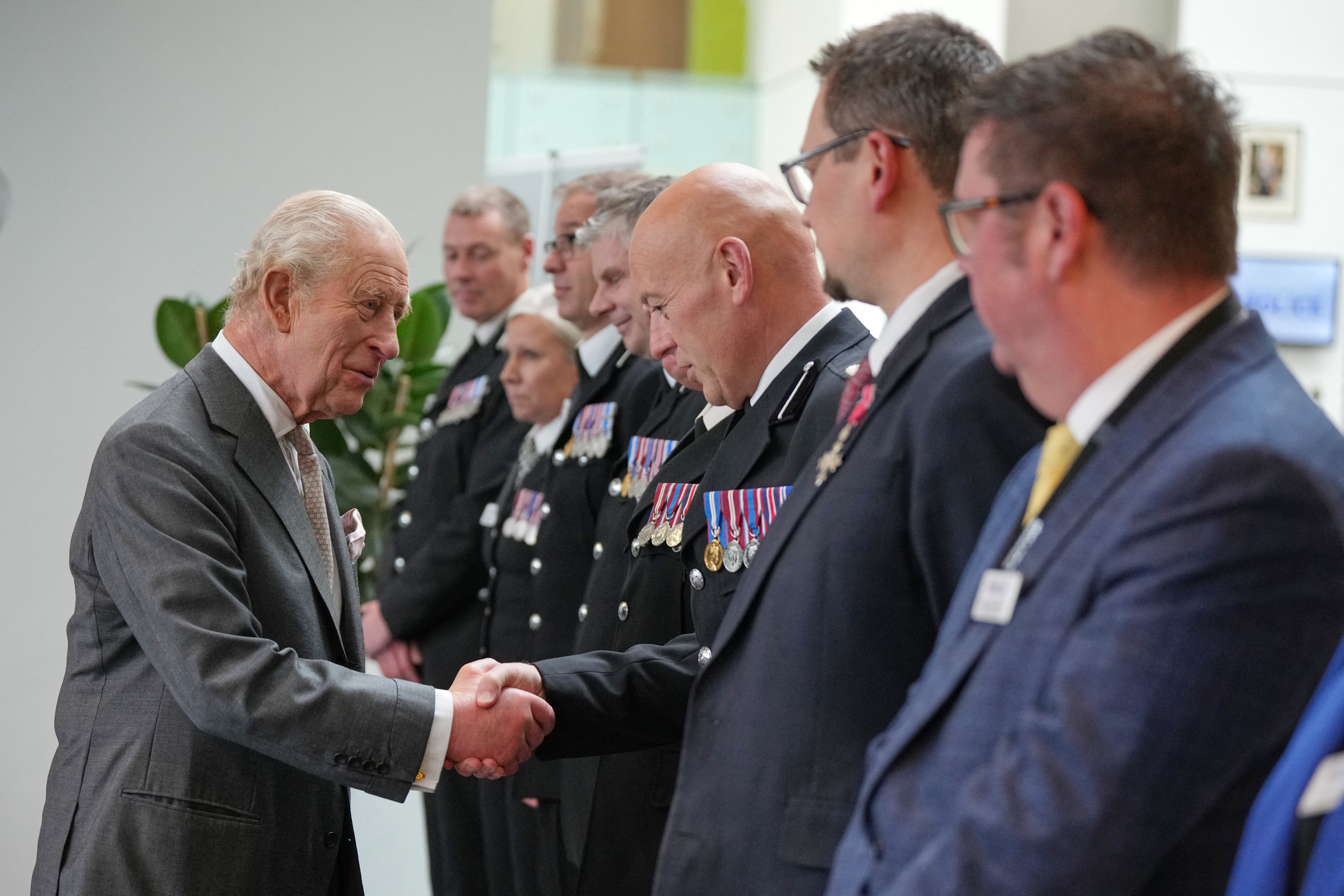 King Charles shaking hands with police