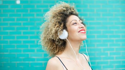 Joyful woman listening to music - stock photo