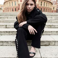 Model on a step wearing AW 24 clothing from AllSaints