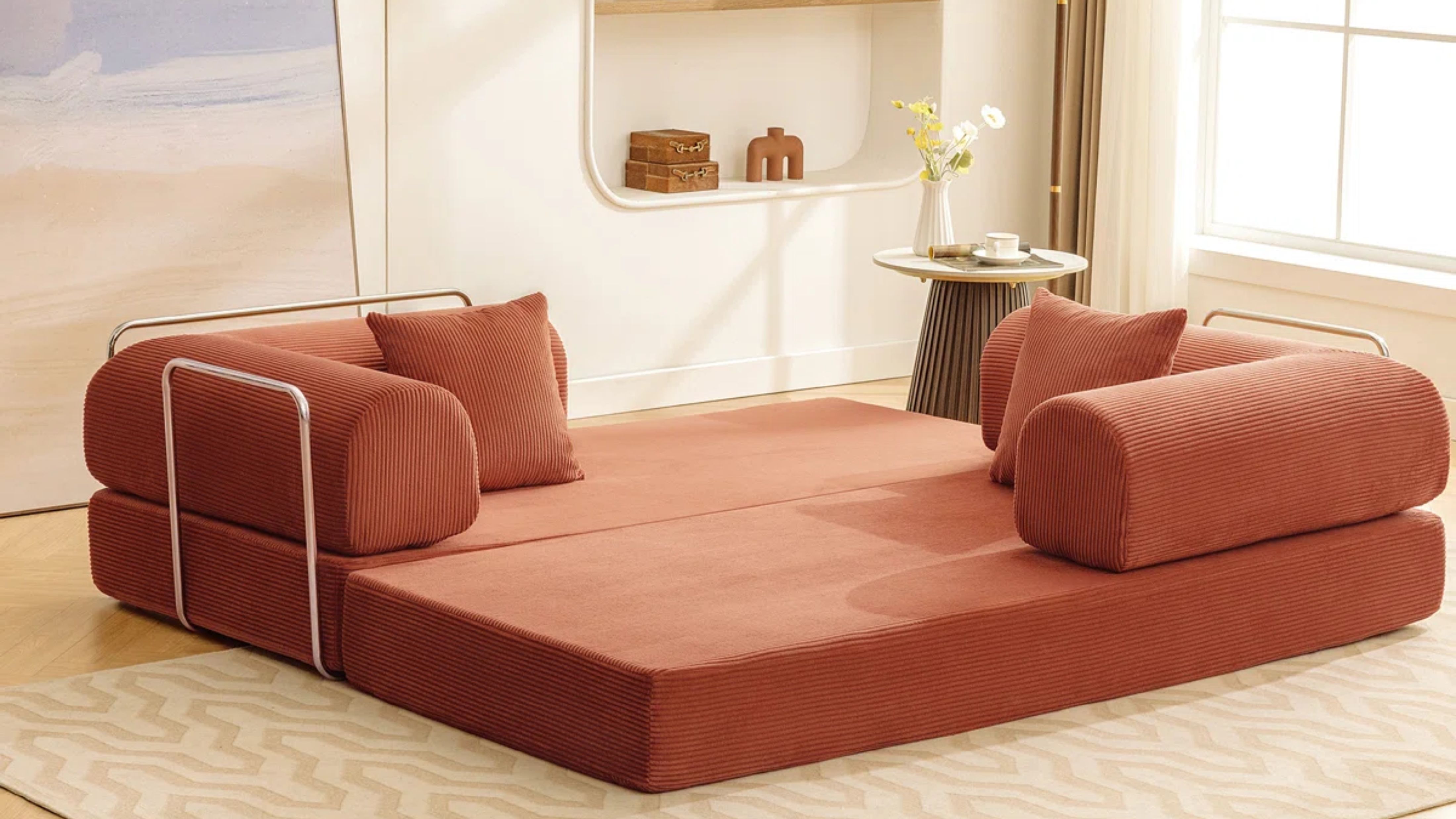 Terracotta conversation pit styled in a cream-colored living room alongside a fluted side table and floor lamp.