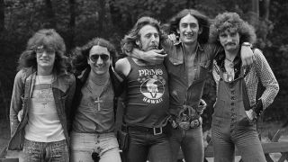 Uriah Heep pose outside with their arms around each other in 1972