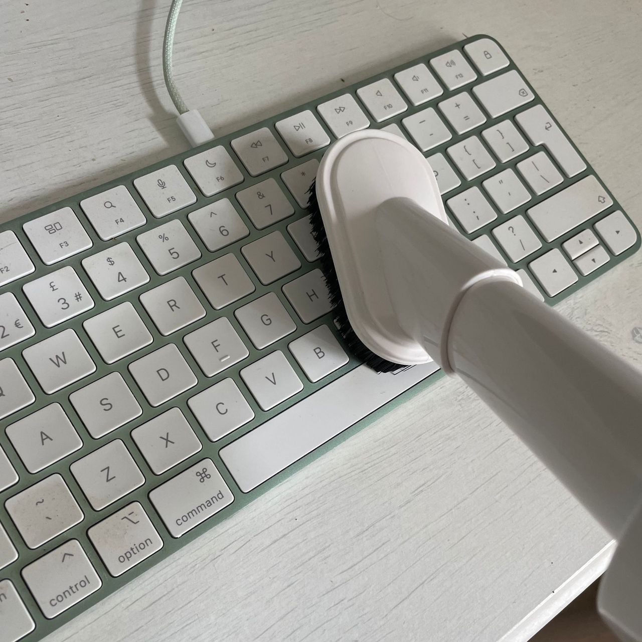 Using the Gtech AirFOX Platinum Cordless Vacuum to vacuum a computer keyboard