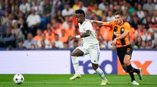 Real Madrid's Vinicius Junior and Shakhtar Donetsk's Maryan Shved challenge for the ball during the UEFA Champions League match between Real Madrid and Shakhtar Donetsk on 5 October, 2022 at the Santiago Bernabeu, Madrid, Spain