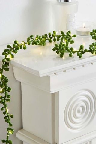 Dunelm String of Pearl Lit Garland draped over fireplace surround