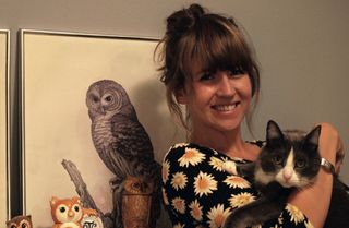 Theo the cat, and plently of owl pictures, keep Fisher company as she runs her design studio from her home in Brooklyn, New York