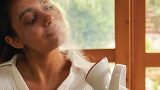 woman using facial steamer