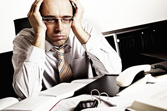 stressed and tired businessman at his desk.