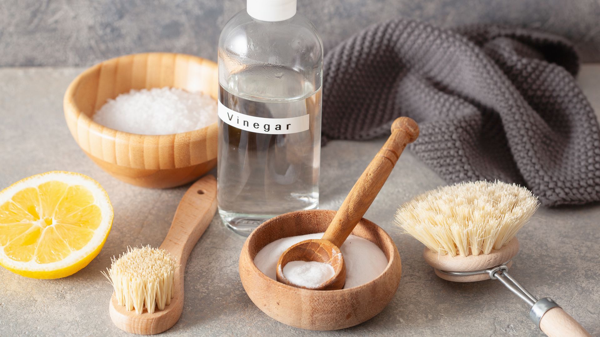Vinegar and baking soda shown with cleaning cloths as a solution for how to clean a mattress