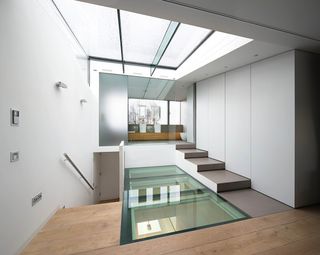 The centre of the house through a skylight and a glass floor in the upper level
