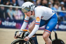 Katie Archibald riding inside a velodrome wearing GB kit