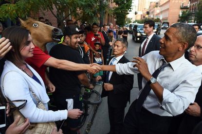 Man wearing horse-head mask gets handshake with President Obama
