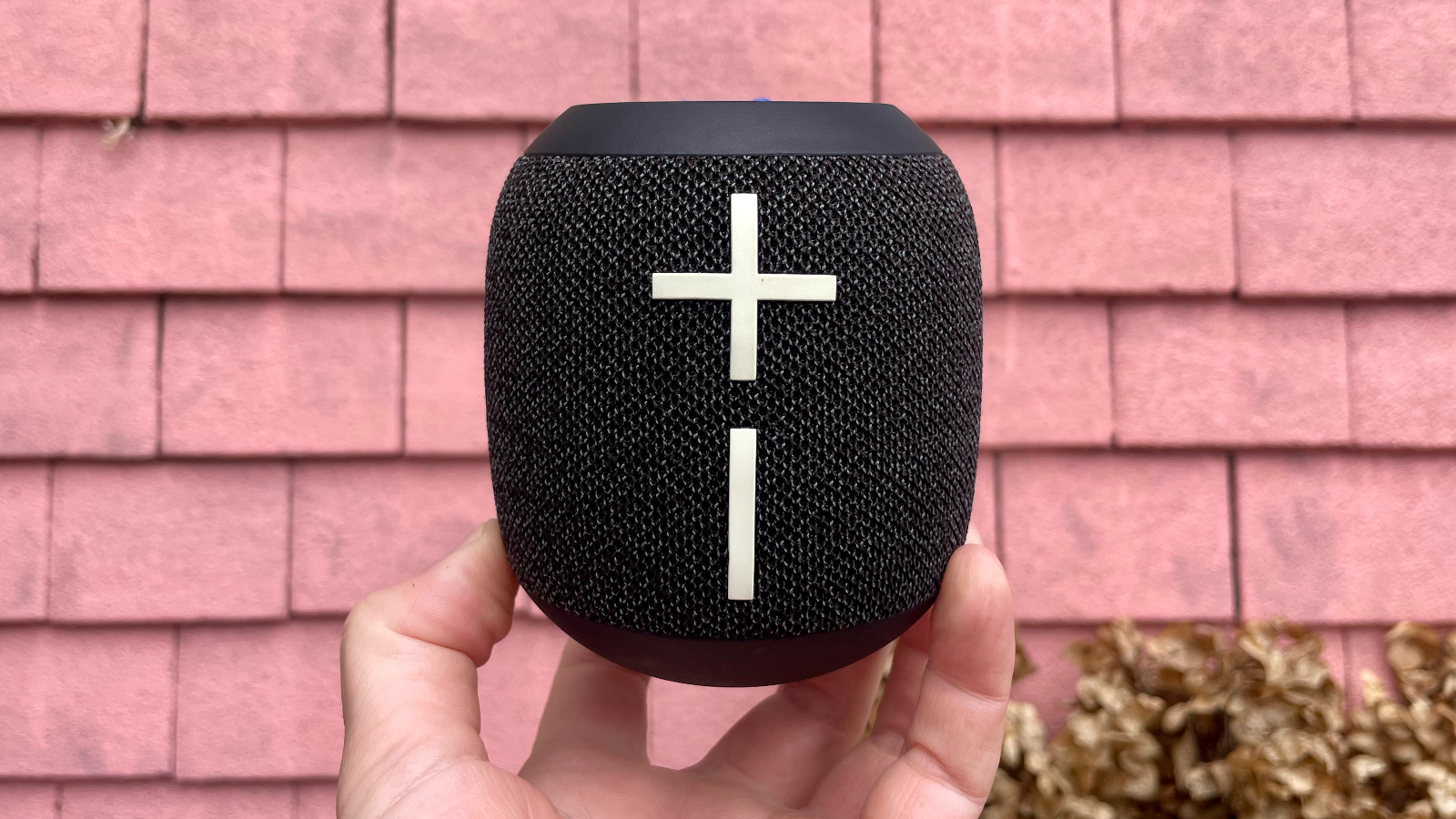 Ultimate Ears Wonderboom 4 Bluetooth speaker against a pink wall