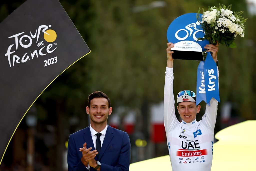 Tadej Pogačar (UAE Team Emirates) celebrates on the podium with the final best young riders white jersey