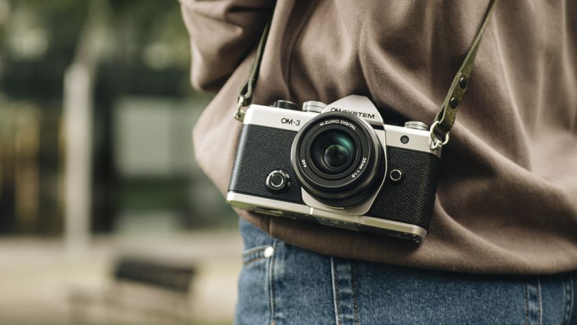 OM System OM-3 mirrorless camera slung over the shoulder