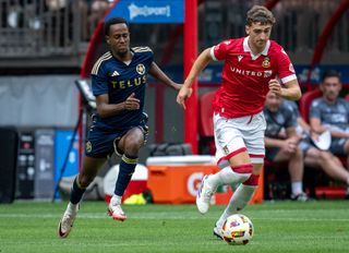 Forward Ali Ahmed #22 of the Vancouver Whitecaps and Wrexham AFC defender Lewis Brunt #3 vie for the ball during the first half of a pre-season friendly at BC Place on July 27, 2024 in Vancouver, Canada.