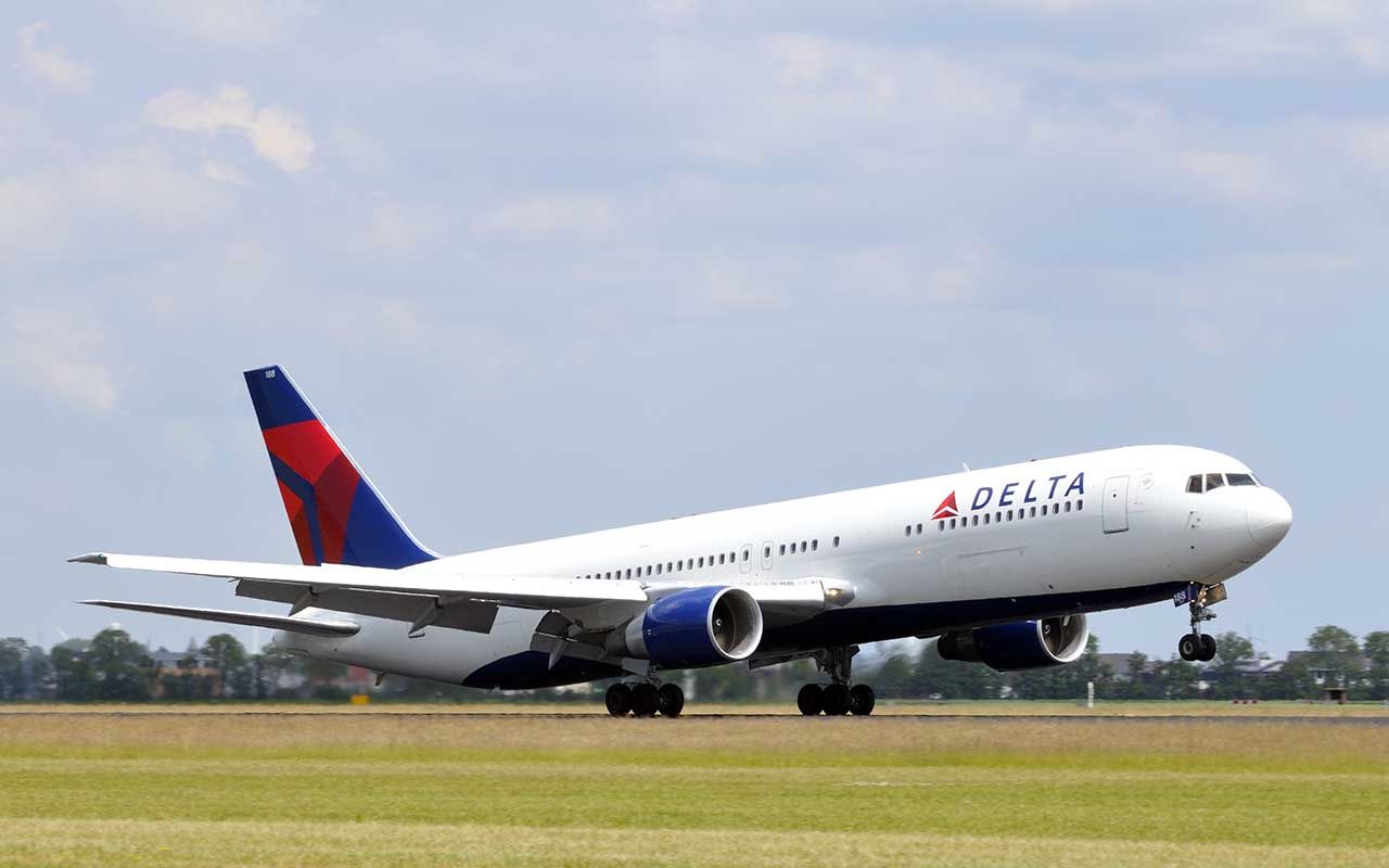 Delta airlines N188DN Boeing 767 plane taking off from Schiphol Airport in The Netherlands on a sunny day.