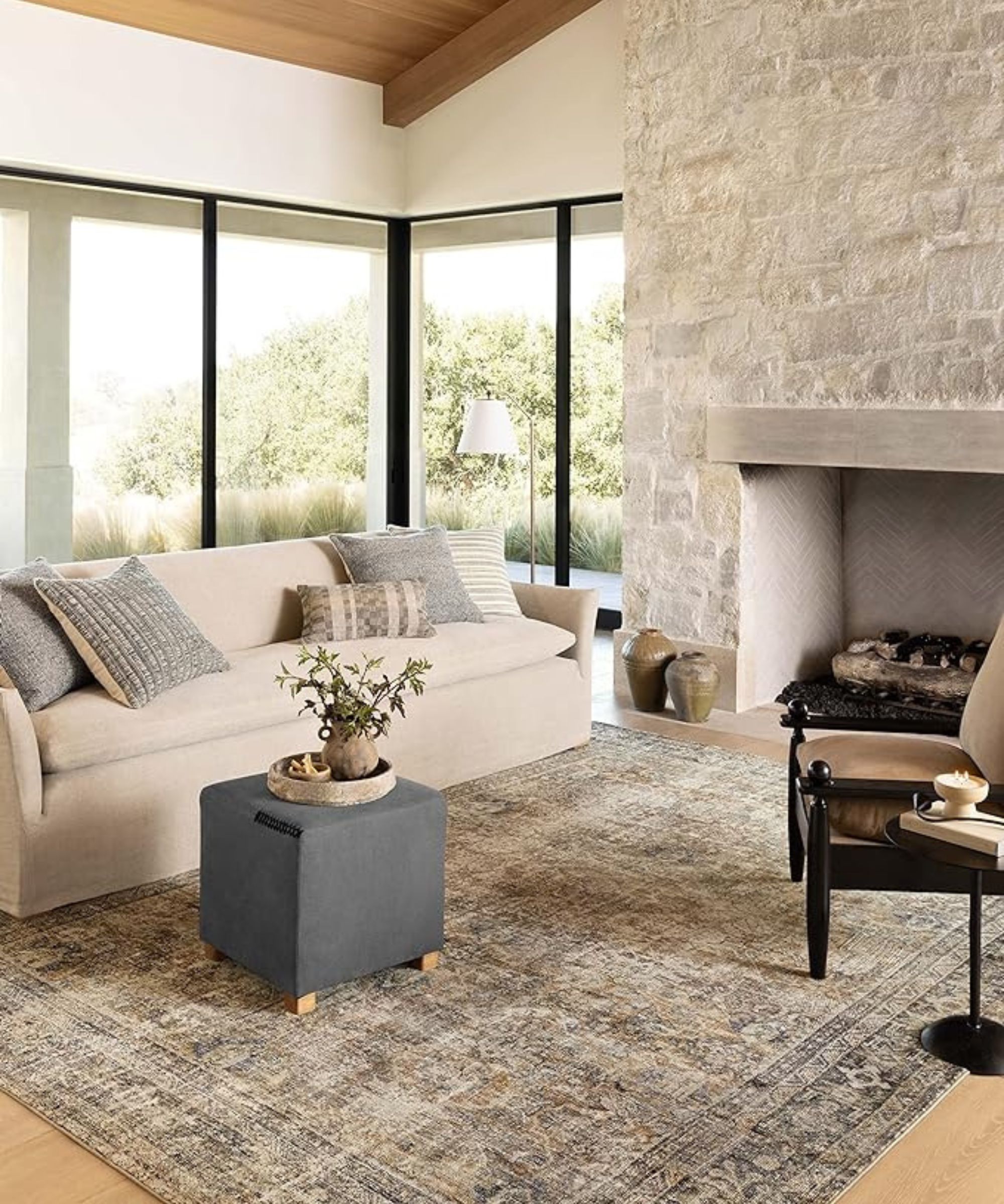 A neutral living room with a vintage-inspired area rug from the Amber Interiors x Loloi Rugs collaboration