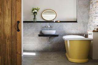 yellow boat bath in farmhouse style bathroom