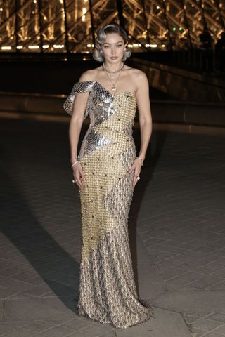 celebrity guests arrive at the inaugural grand diner du louvre in paris wearing designer fashion