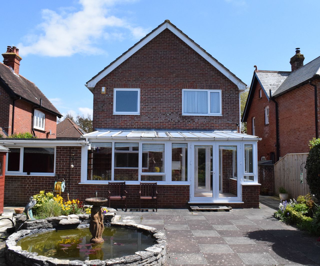 Before shot of the rear exterior of a 1970s home before it's demolished and rebuilt