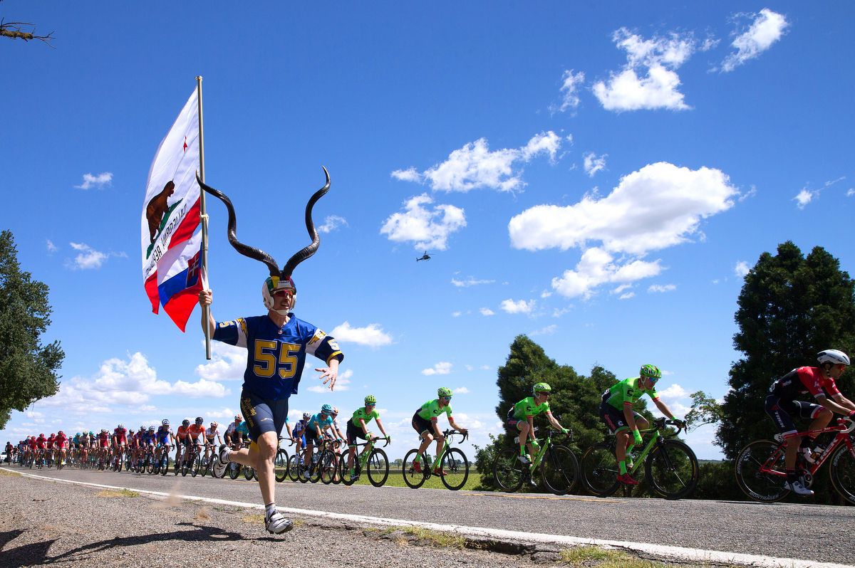 A fan running roadside to cheer on the peloton