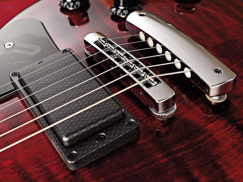Carbon-like covers, new hardware and the red finish hammer home the modern vibe