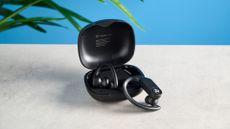 a pair of black earbuds for working out with ear hooks and a big charging case Treblab X3 Pro