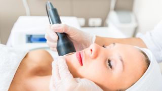a woman getting laser hair removal in a clinic